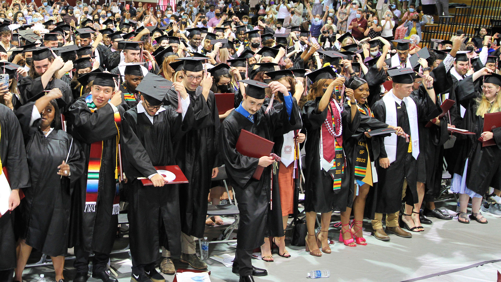 Students turn their tassels, all at once, to signify their graduation from Guilford College.