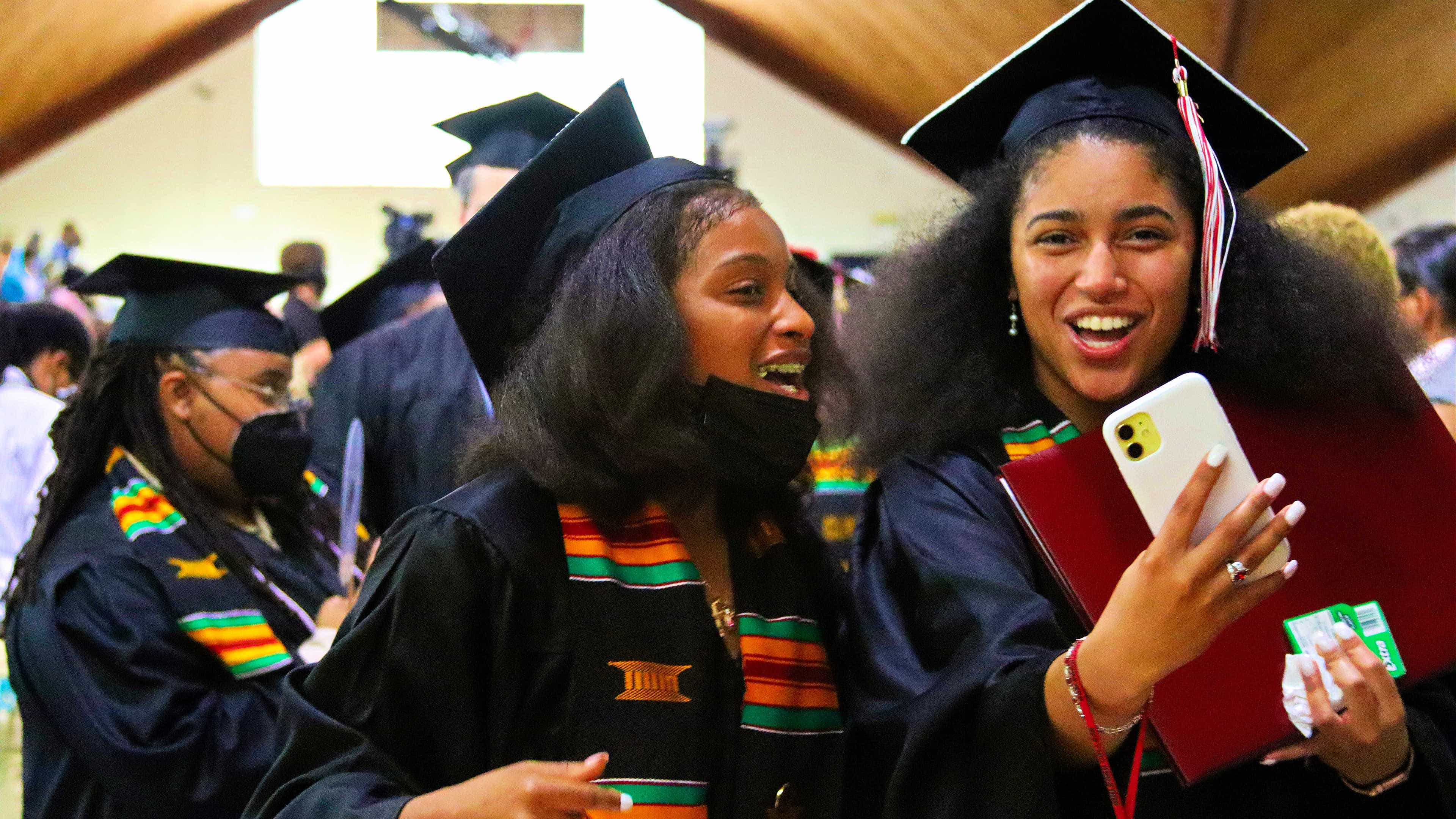 Two students take a selfie after Commencement.