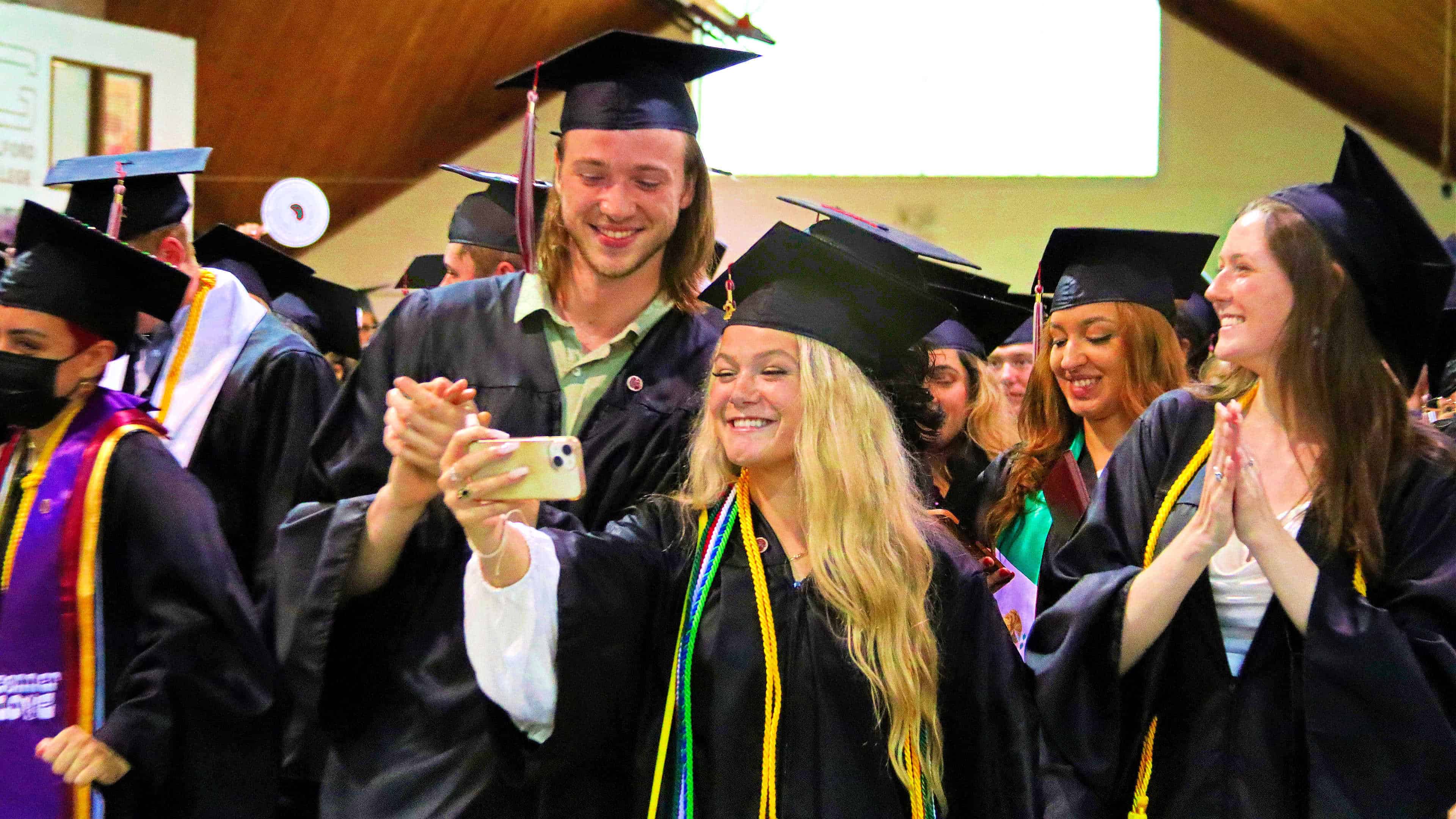 Two students take a selfie after Commencement.