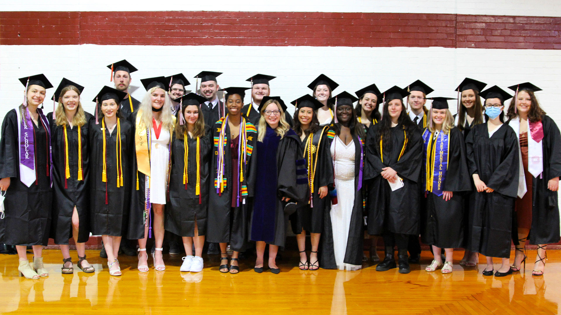 English Professor Heather Hayton stands with Honors students before Commencement.