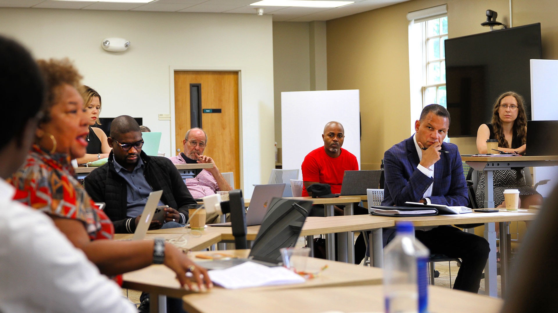 President Kyle Farmbry seats amid attendees seated in a circle at pre-forum activities at the Guilford Dialogues.