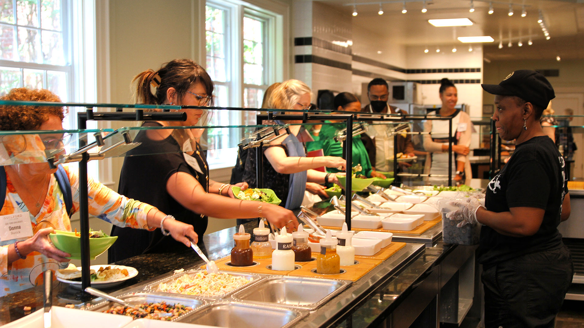 Attendees fill their plates at the salad bar in the Dining Hall during the Guilford Dialogues.