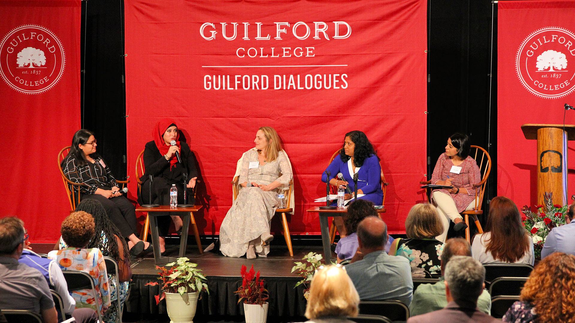 Seated on stage at the Guilford Dialogues are, from left: Maria Gonzalez, Hourie Tafech, Colleen Thouez, Esther Benjamin, and Sonalini Sapra.
