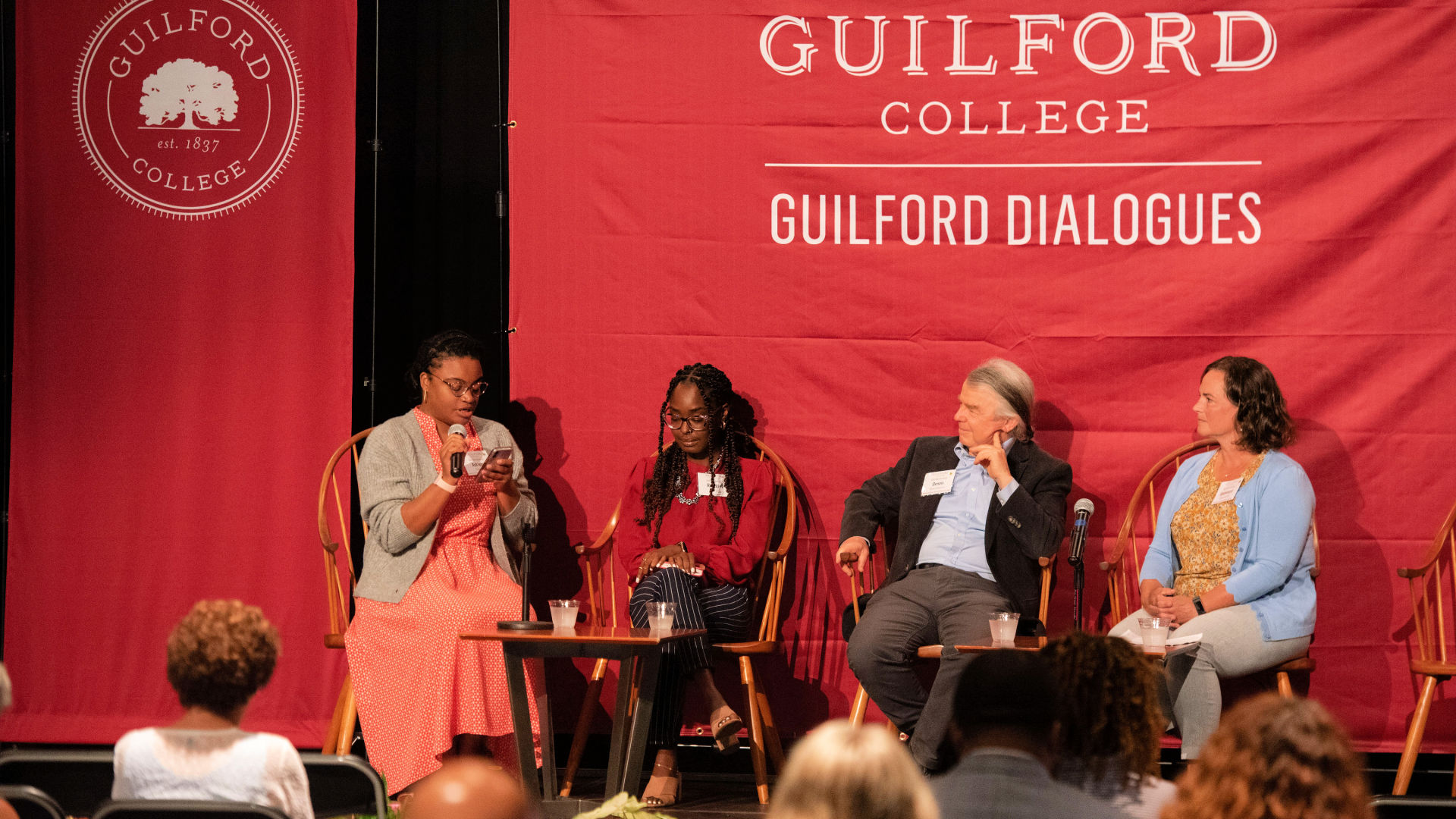 Seated on stage at the Guilford Dialogues are, from left: Adriane Clomax, Roodline Volcy, Dennis Quaintance, and Guenevere Abernathy.