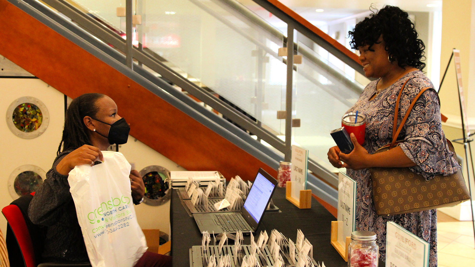 An attendee checks in with a Guilford staffer at the Guilford Dialogues.