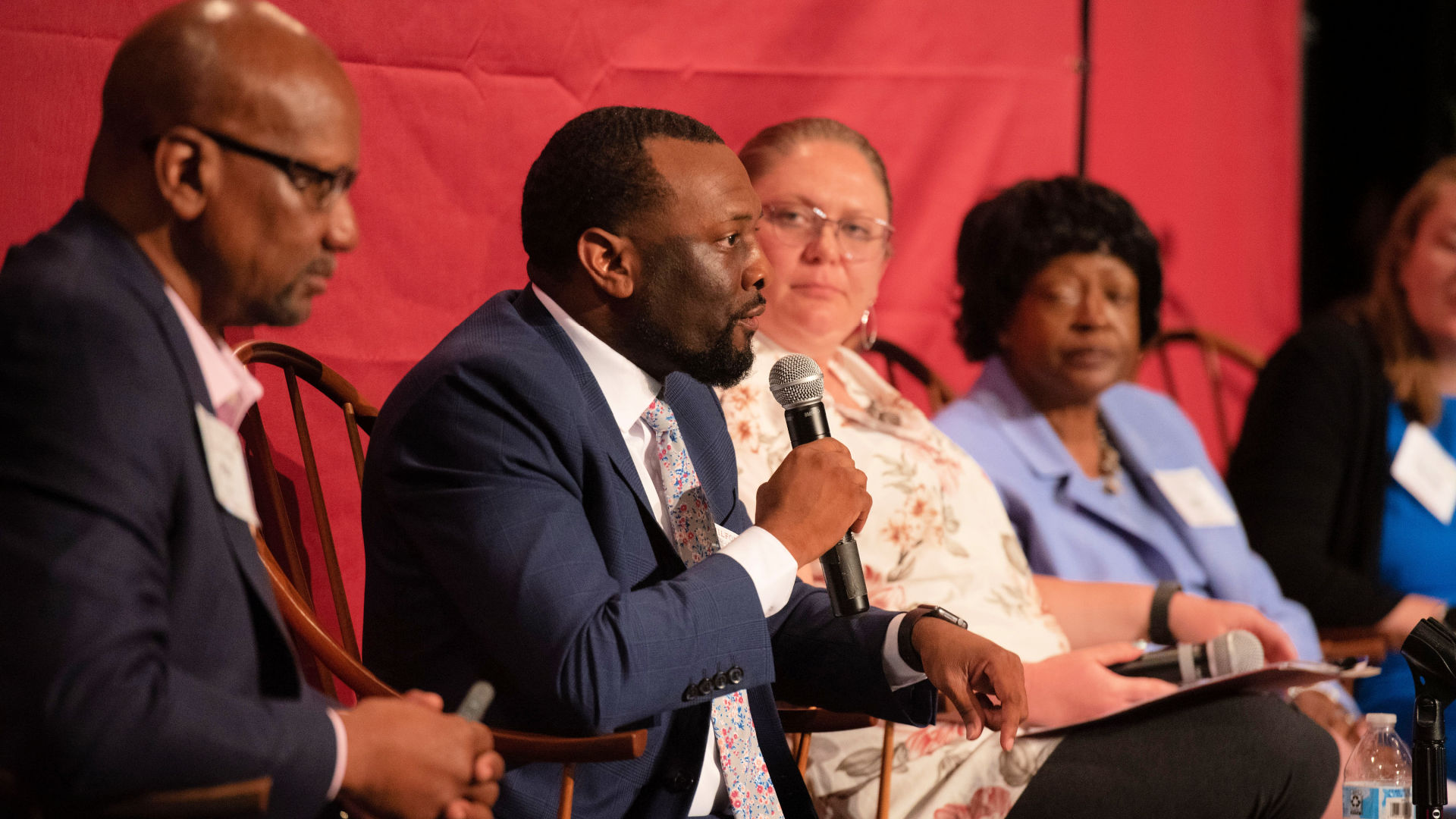 On stage at the Guilford Dialogues, seated in chairs, from left: Mac Sims, Marvin Price, Dayna Carr, and Joyce Hobson Johnson.