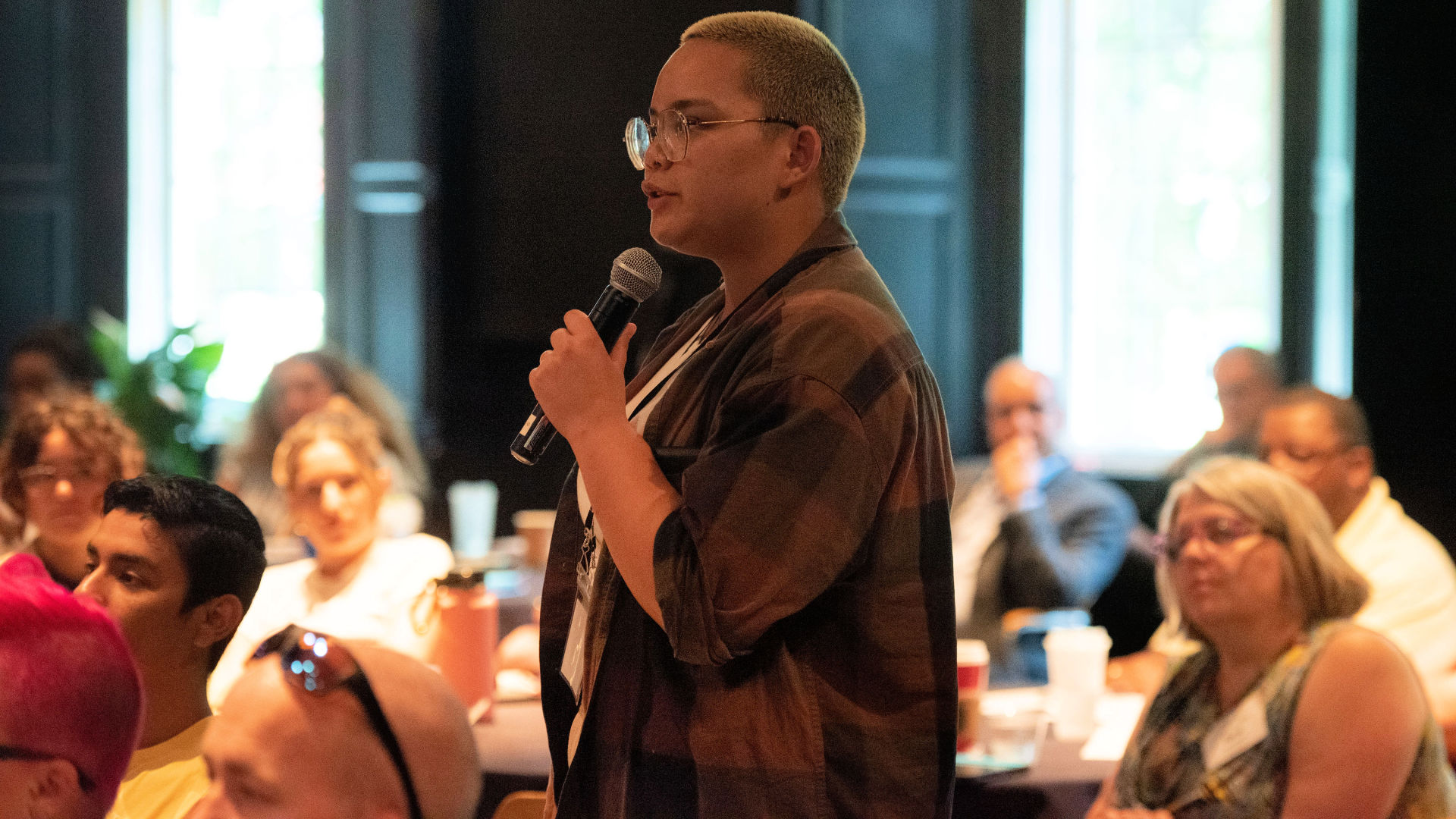 A student attendee stands to ask their question during the Guilford Dialogues.