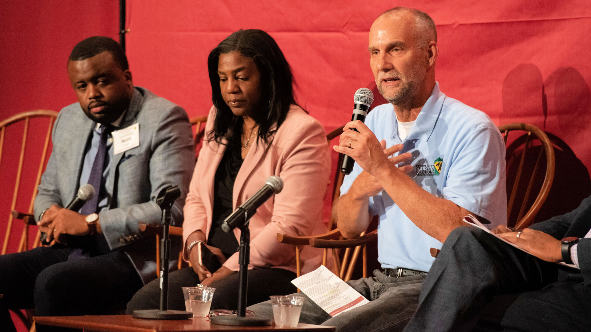 On stage at the Guilford Dialogues, seated in chairs, from left: Marcus Thomas, Josie Williams '16, and Gene Brown.