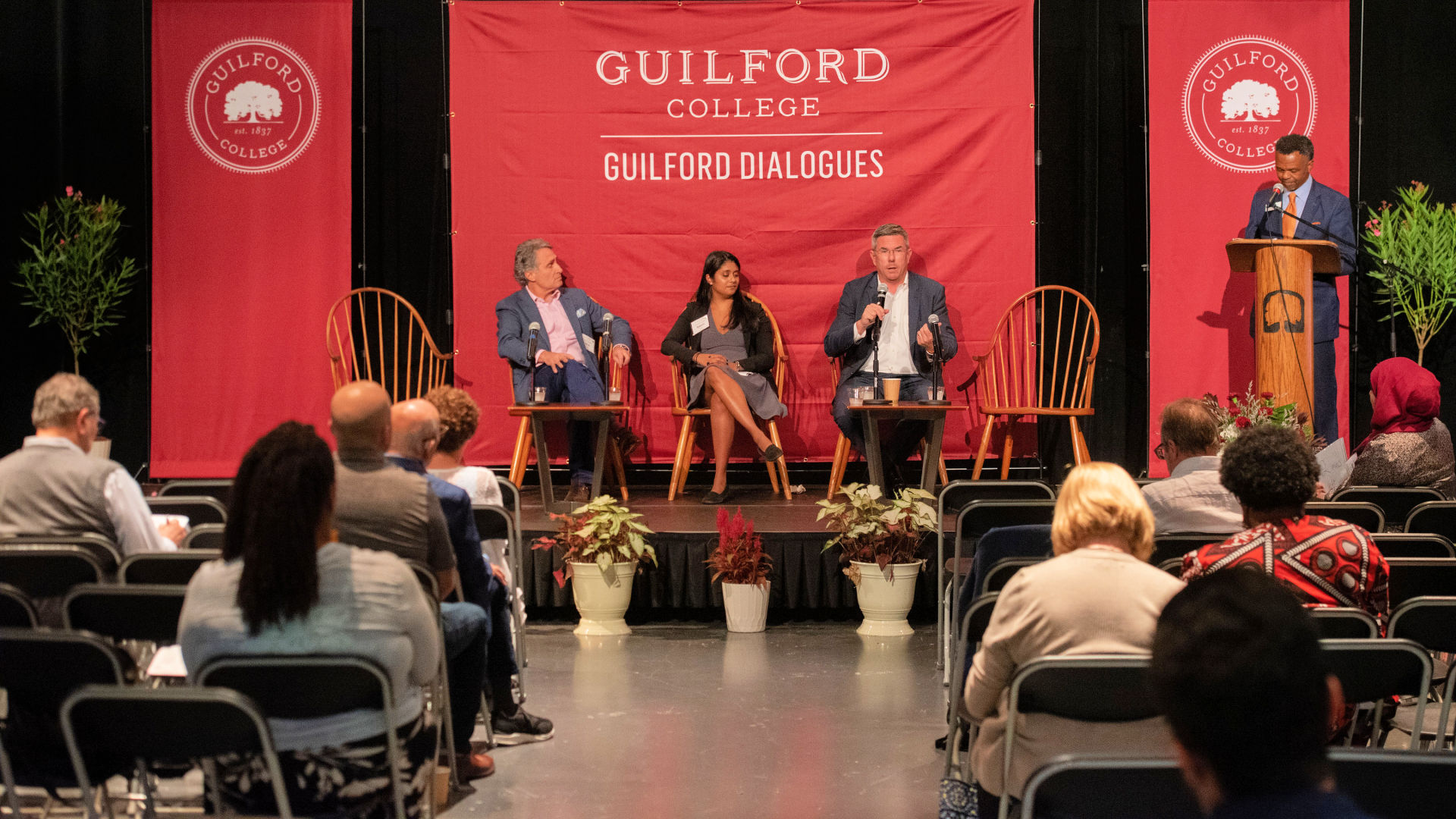 On the stage at the Guilford Dialogues, from left: Byron Loflin, Roberta Lobo, Graham Macmillian, and Danny Gatling.