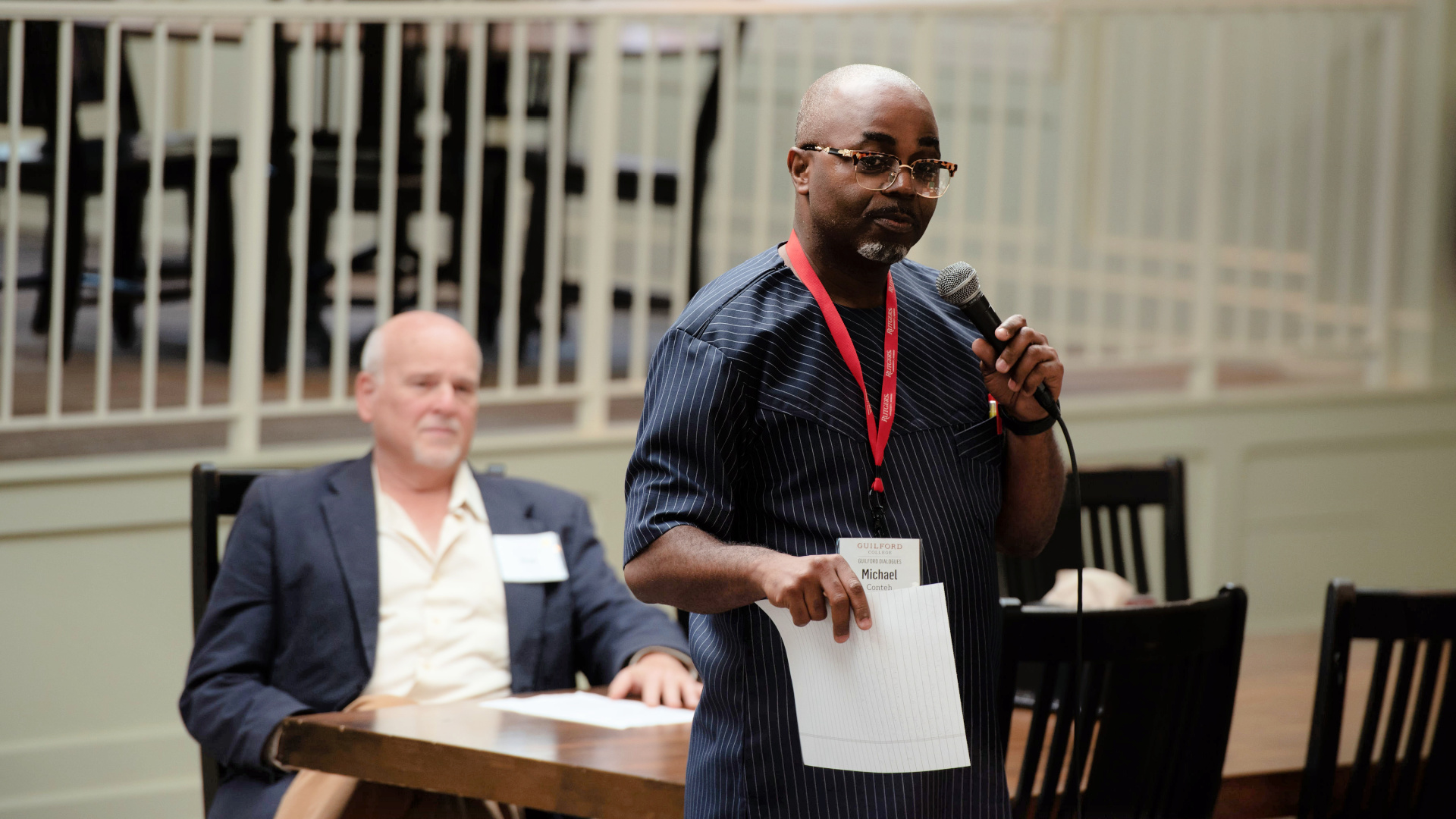 A speaker talks to the audience in the College's Dining Hall.