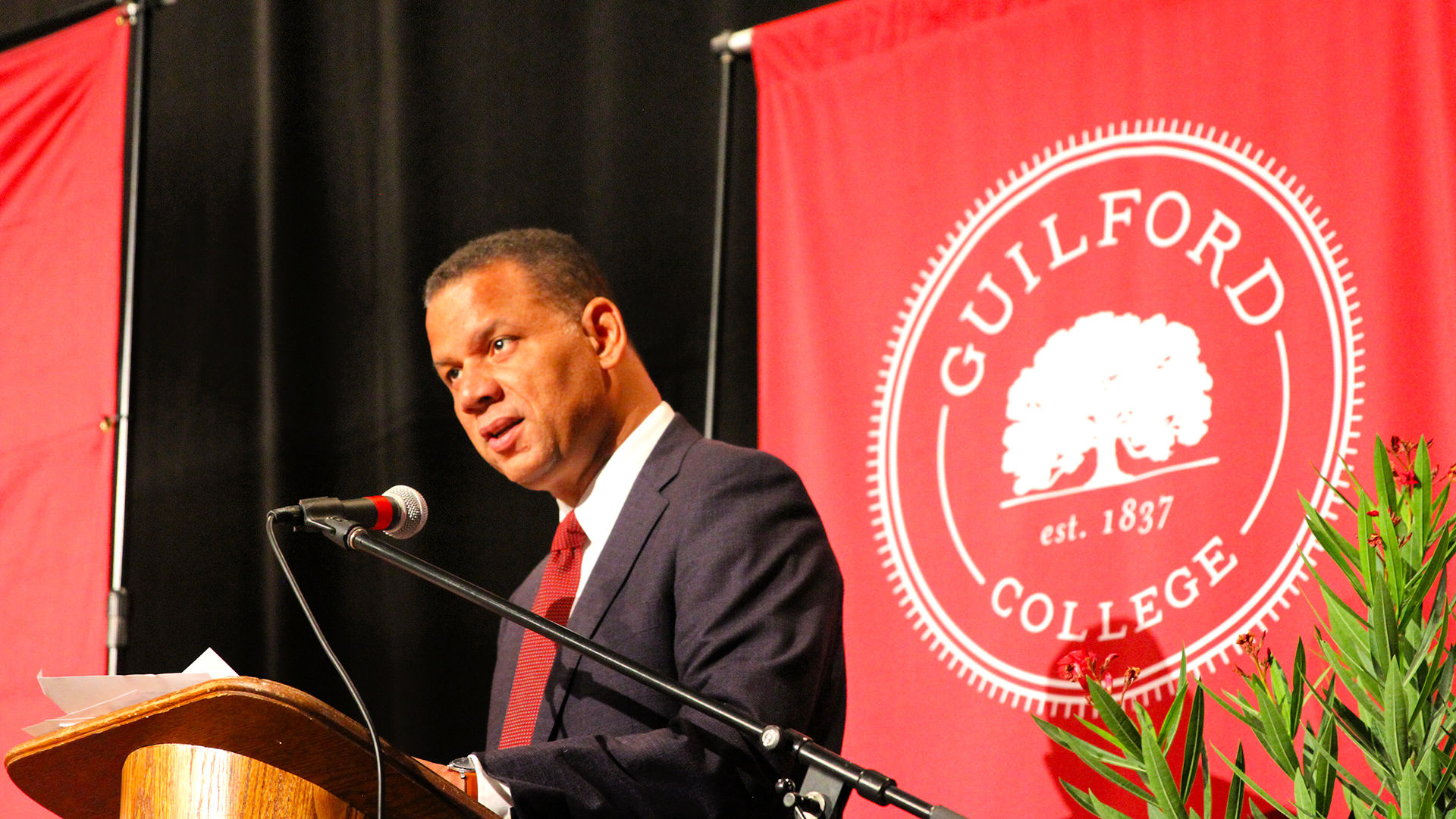 Guilford College President Kyle Farmbry speaks from the podium to open the first full day of the Guilford Dialogues.