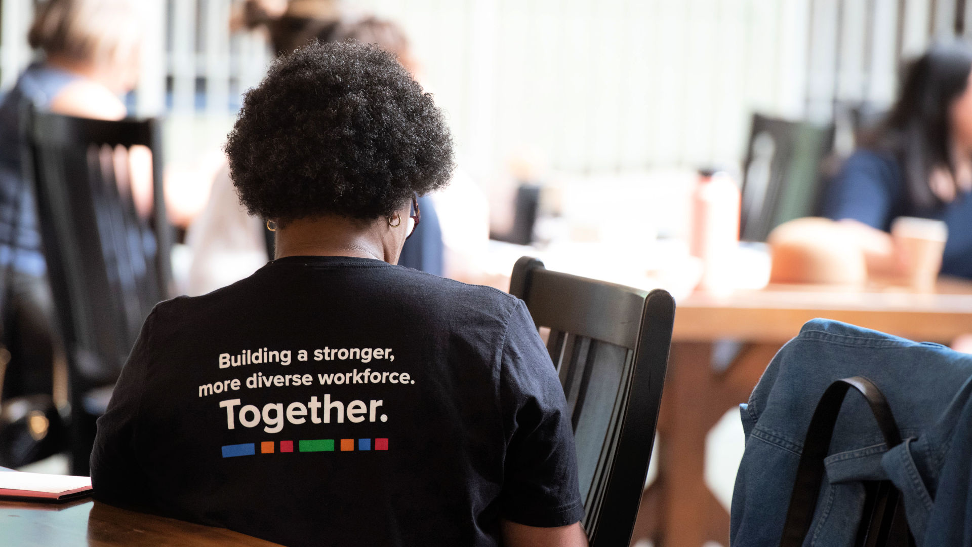 A Dialogues attendee's shirt reads, "Building a stronger, more diverse work force together."