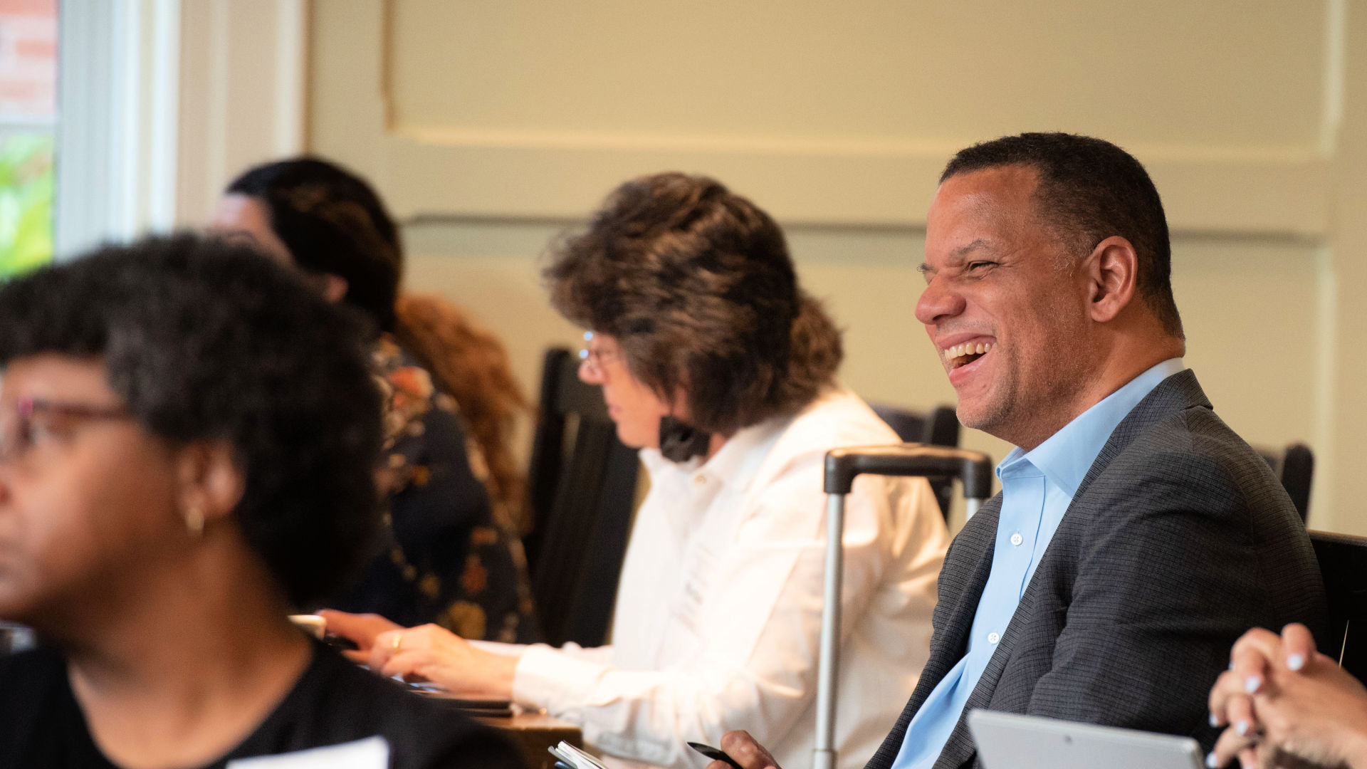 President Kyle Farmbry laughs during the closing session in the Dining Hall at the Guilford Dialogues.