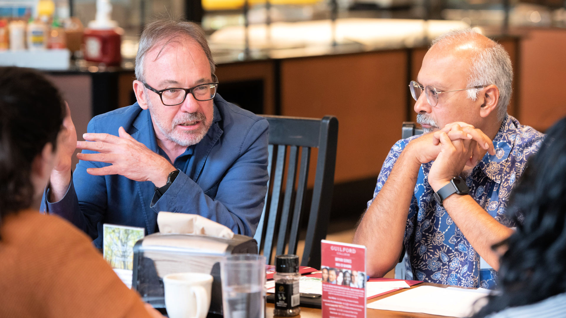 Two attendees chat during the closing session at the Guilford Dialogues.