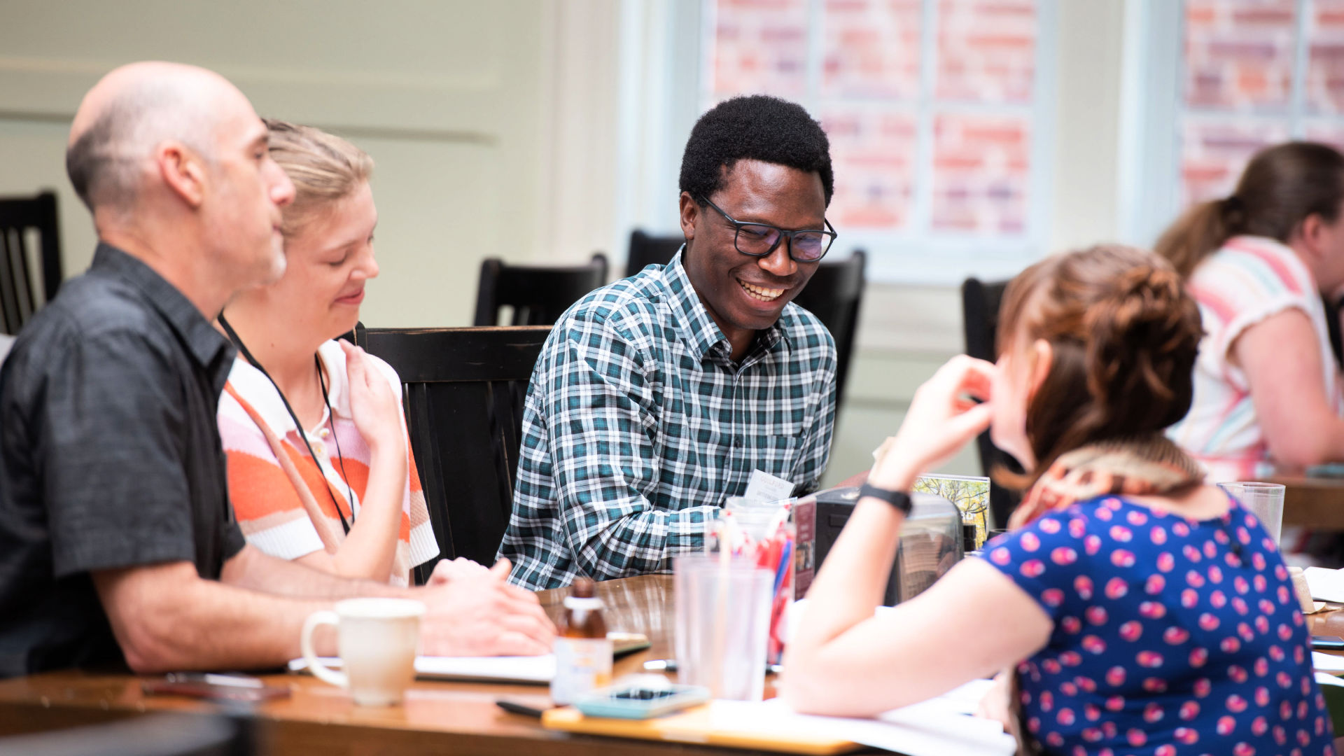 Attendees chat and smile during the closing session of the Guilford Dialogues.