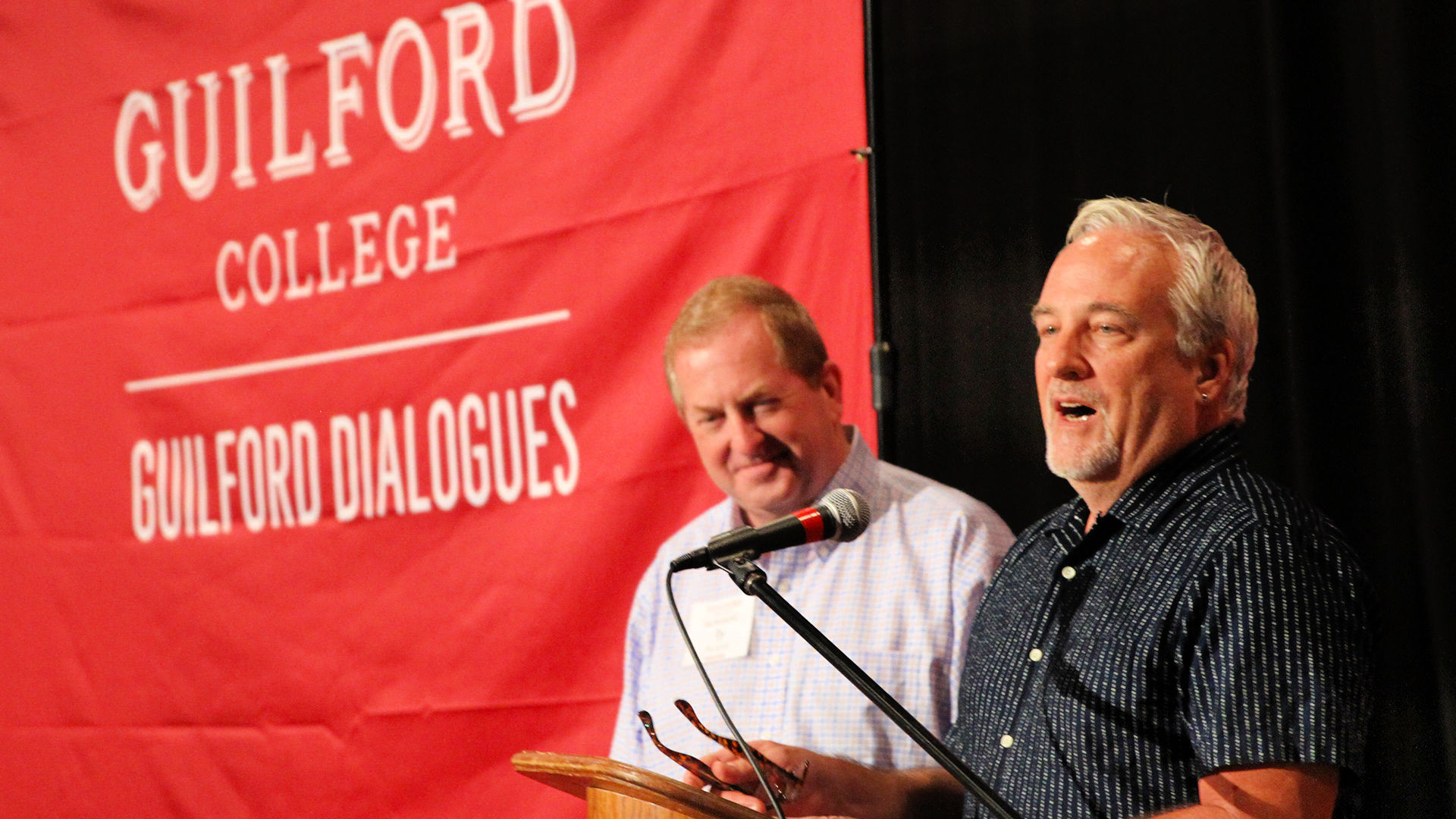 On stage from left at the Guilford Dialogues are Ty Buckner and Tim Raphael.