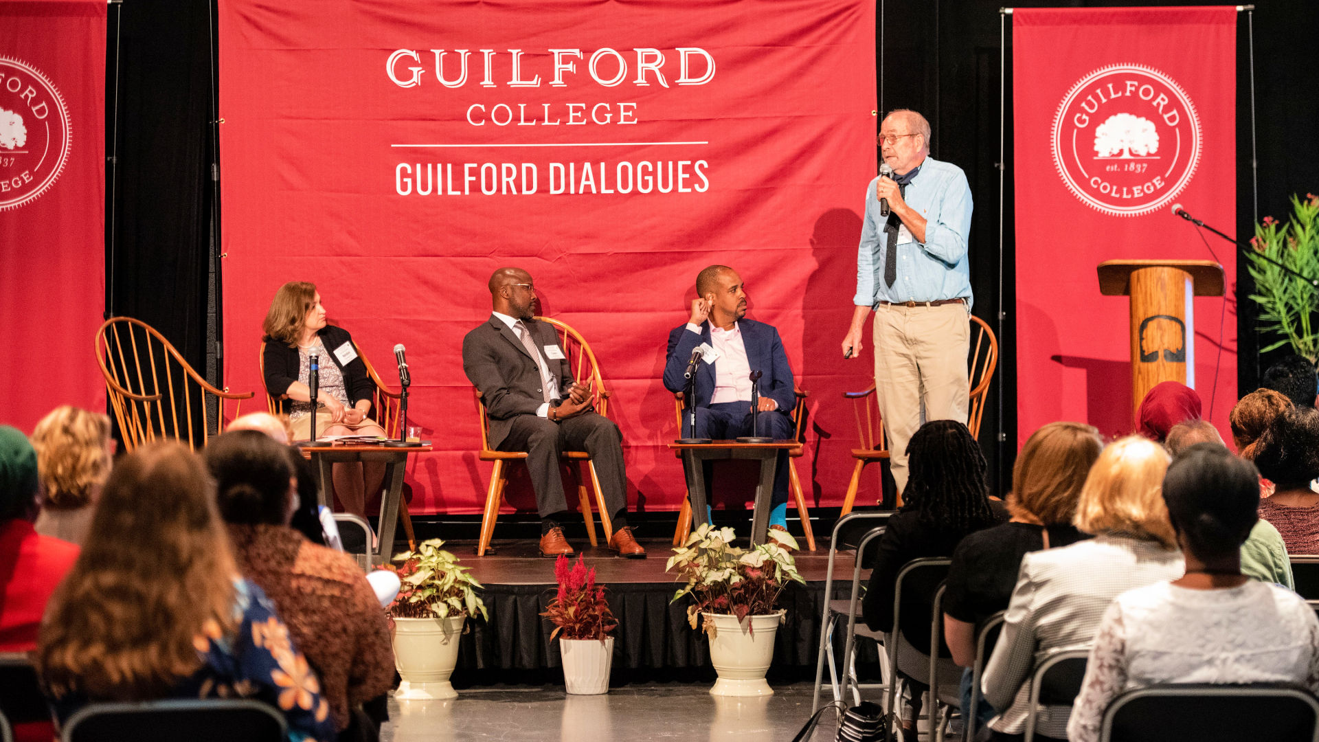 On stage from left at the Guilford Dialogues are: Natalya Shelkova, Taiwo Jaiyeoba, Chris Wheat, and Bob Williams.