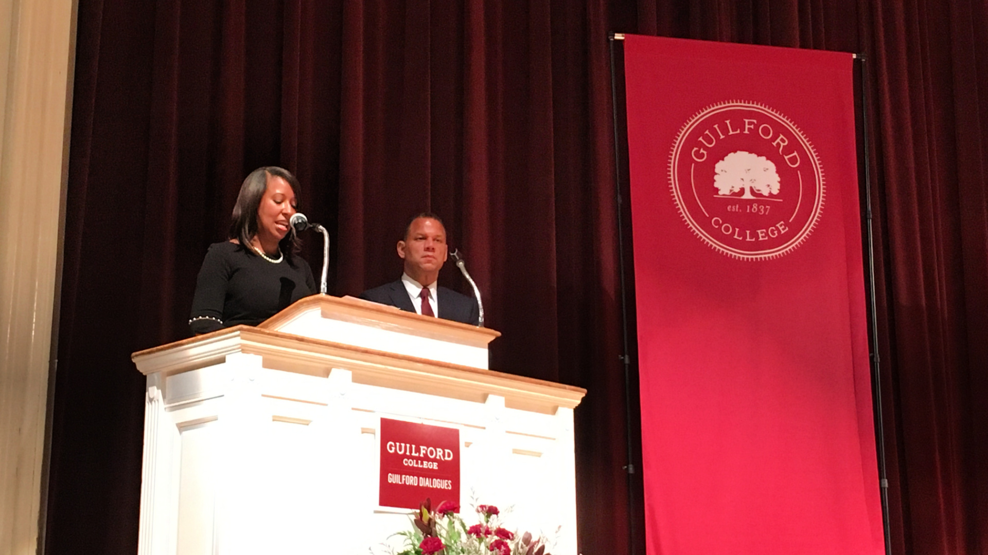 Standing at the podium during the Eugene Robinson event are, from left: LaToya Marsh and President Kyle Farmbry.