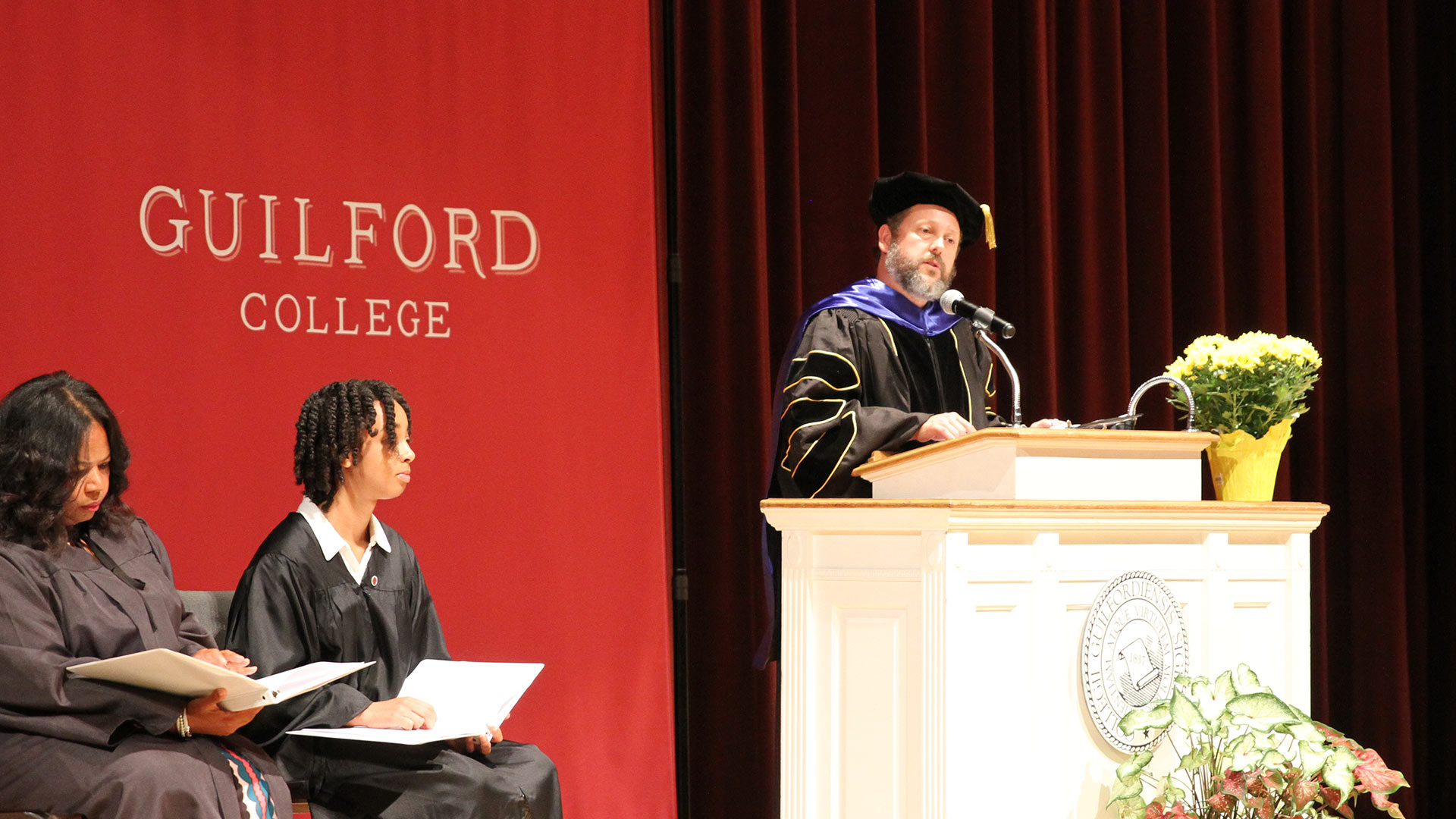 Friends Center Director Wess Daniels speaks from the podium at the start of Convocation.