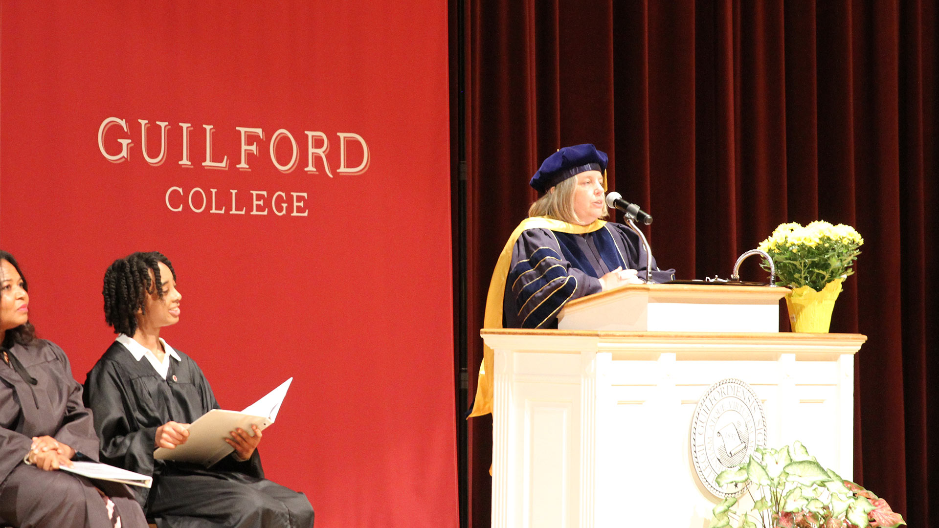 Provost Maria Rosales speaks from the podium at Convocation.