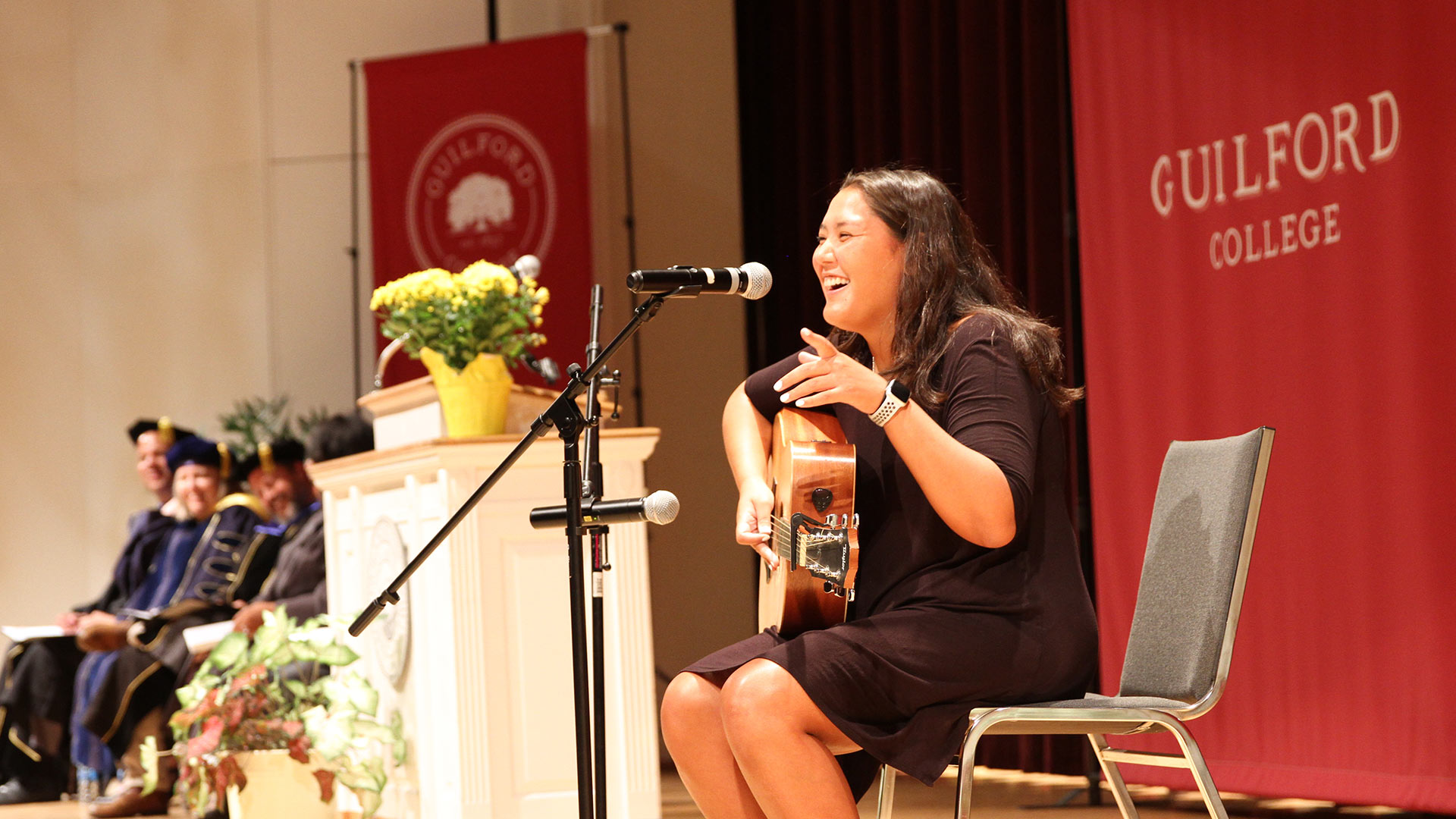 Dana Bederson ’23 plays the guitar on Dana's stage at Convocation.