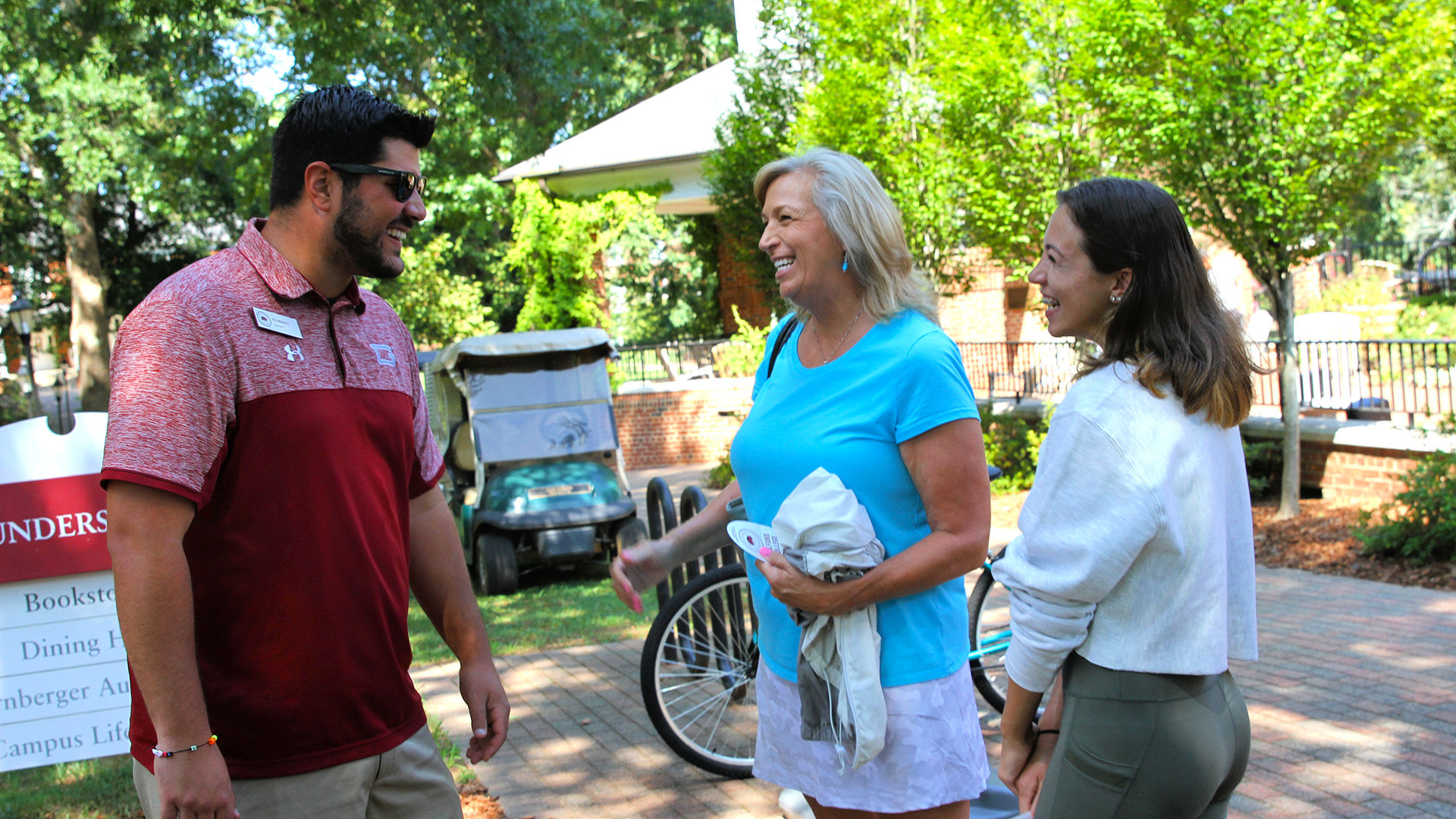 A Guilford Admission Counselor welcomes a student and family member to campus on move-in day.