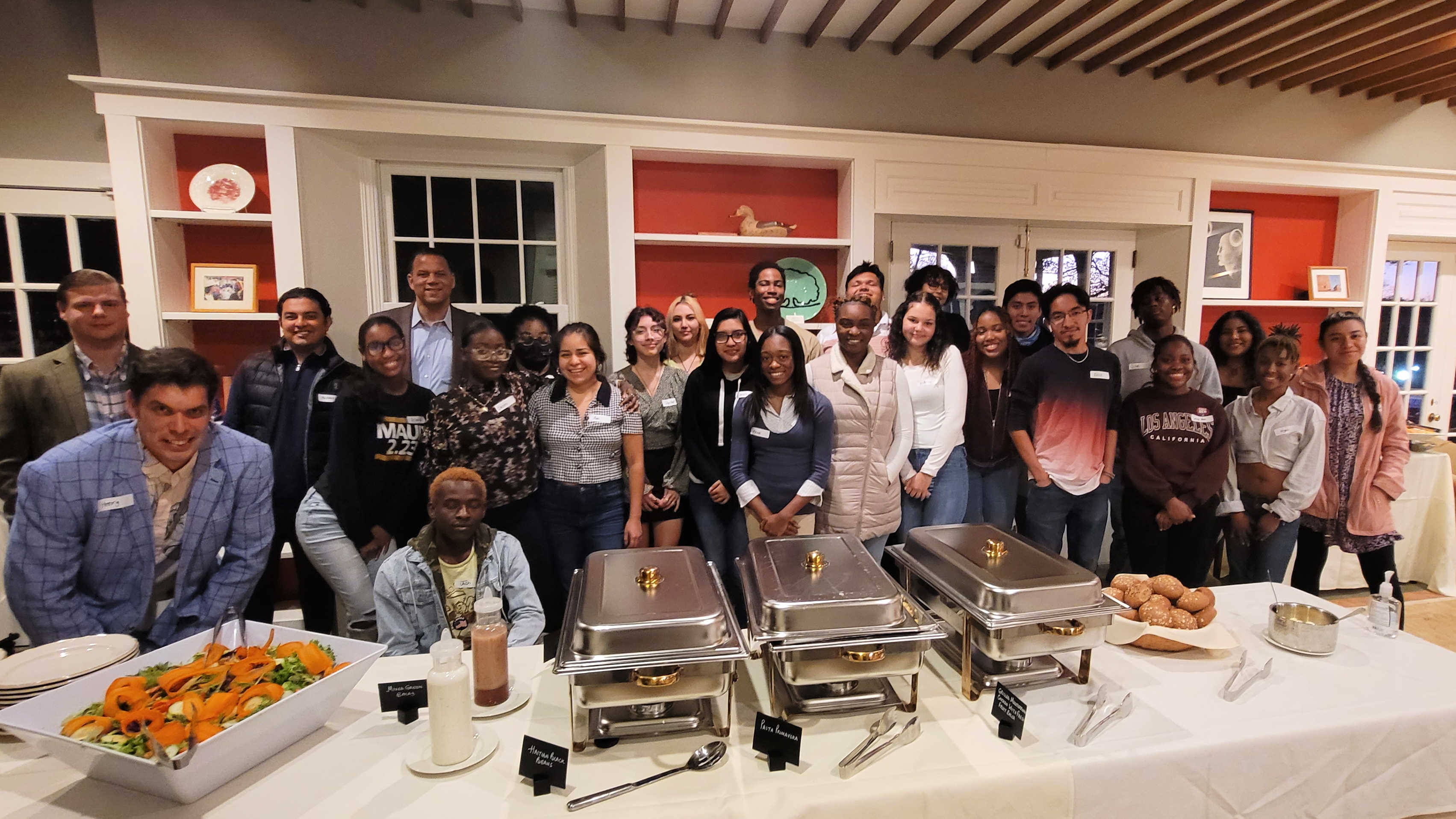 President Kyle Farmbry takes a group photo with all of the first-gen students who attended the President's Dinner at Ragsdale House.