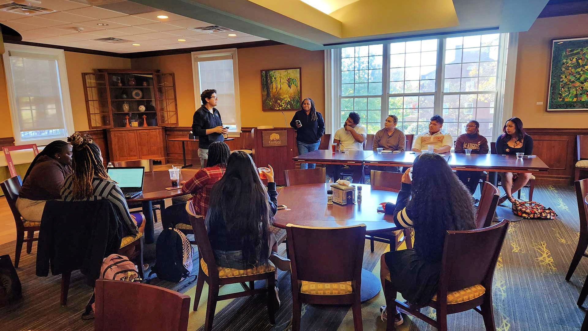 A staff members introduces a panel of students during an event on First Generation College Day 2022.