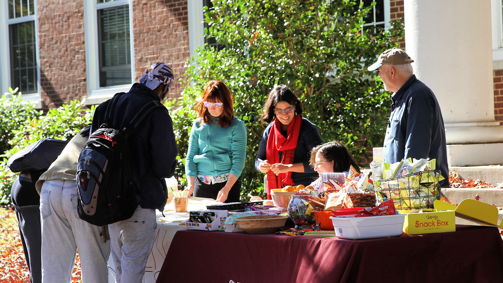 Staff from CPPSET hand out treats to first-gen students in front of King Hall.