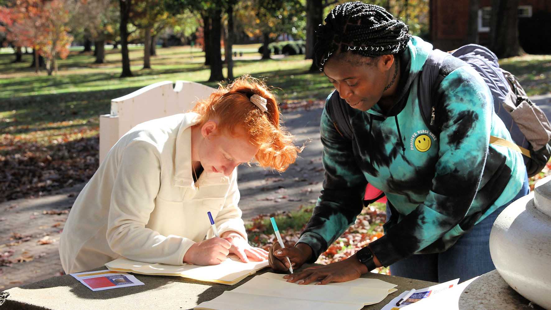 Students write notes on National First Gen College Day 2022.