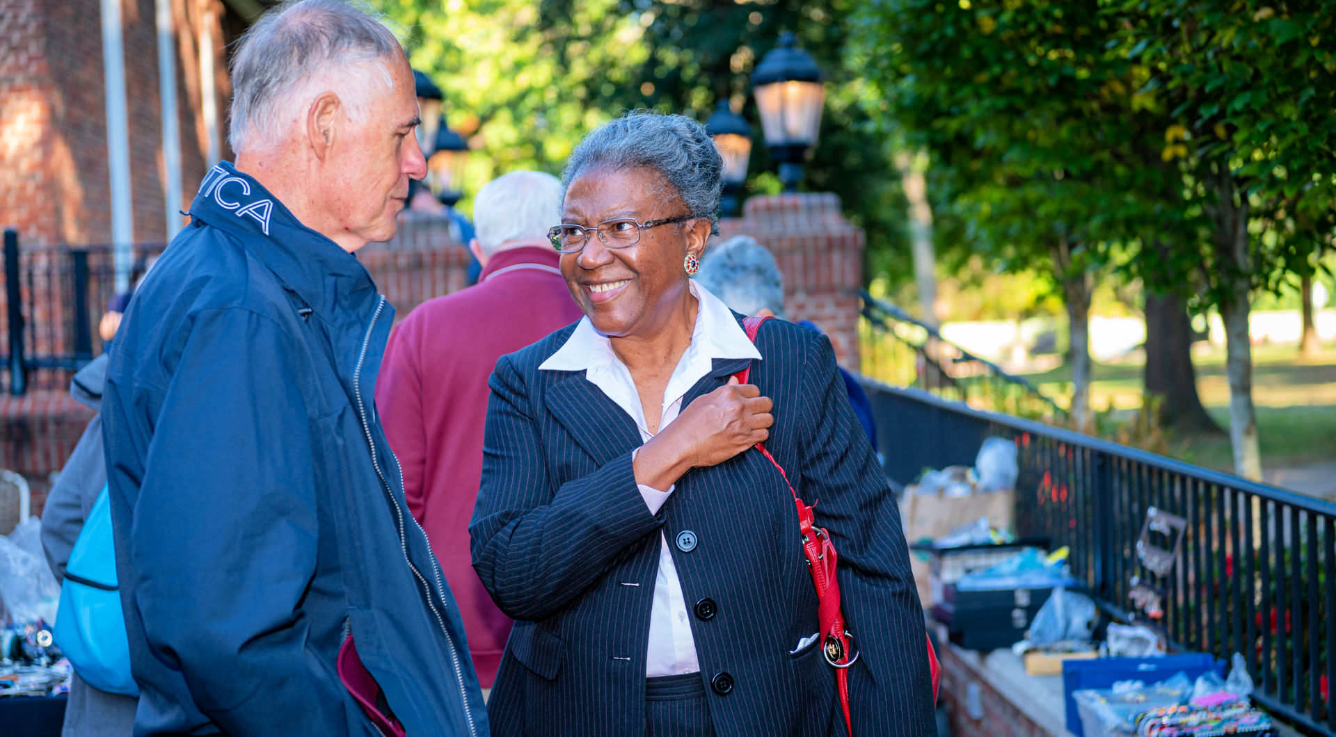 Retired professors Tim Lindeman (left) and Adrienne Israel chat on Founders Hall patio.