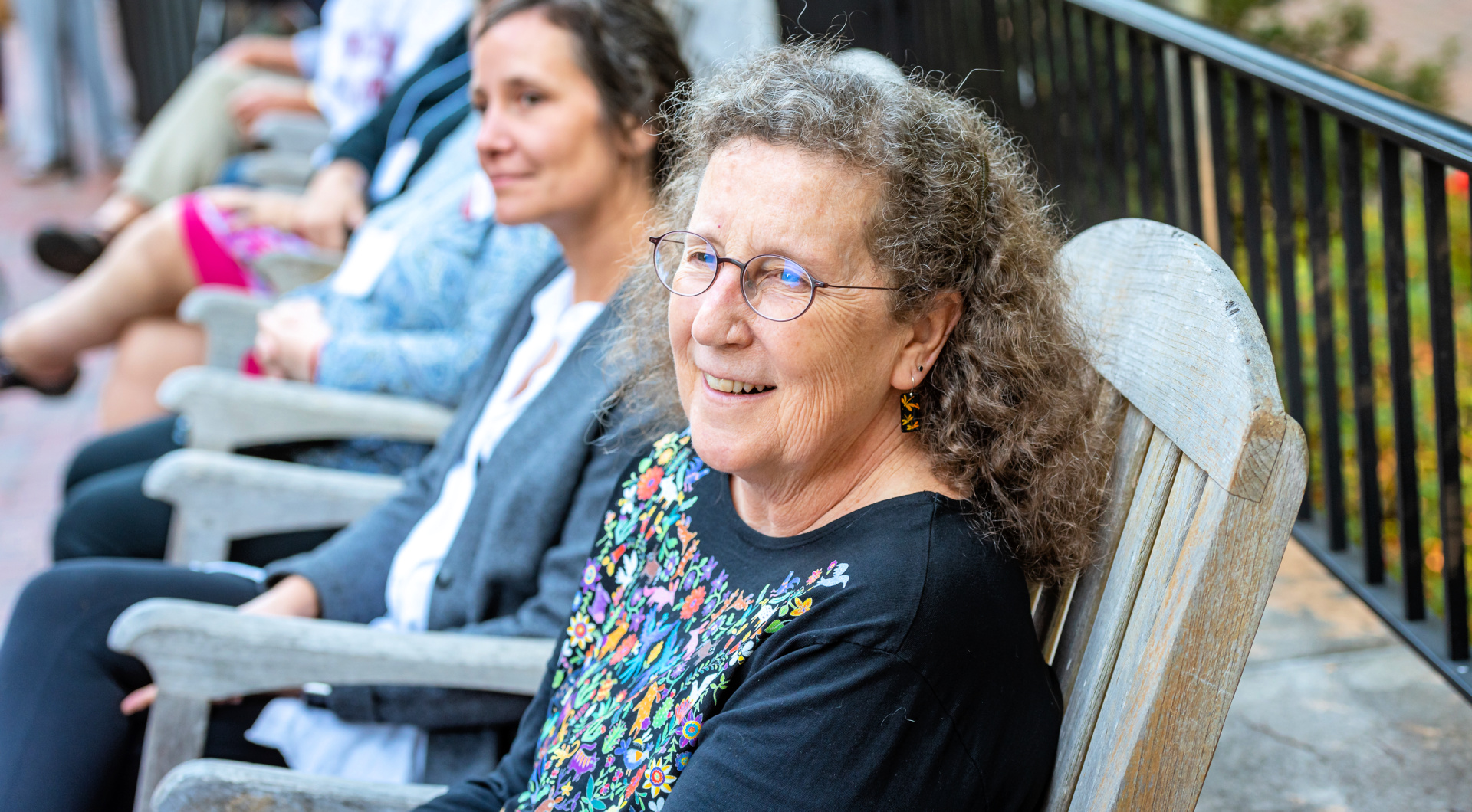 A Guilfordian seated in a rocker attends the Zopf dedication.