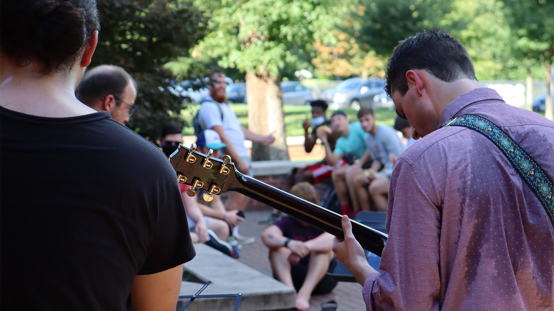 The photographer takes a photo of the crowd as seen in front of the musicians.