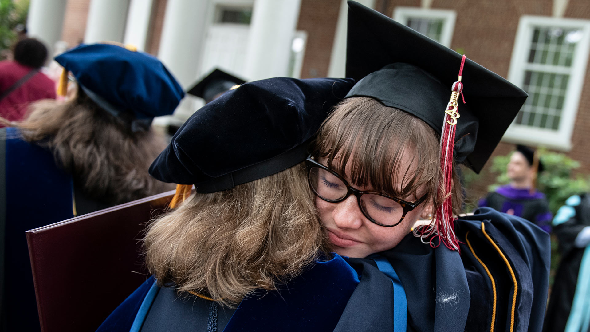 A professor congradulates a graduate