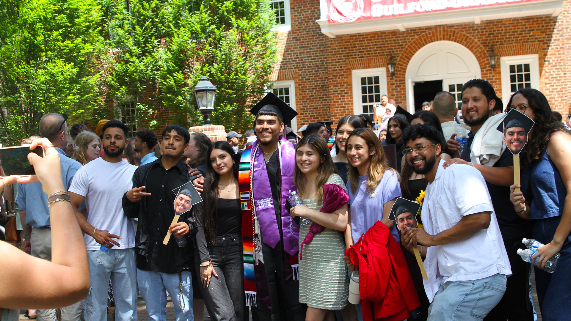 Well-wishers greet recent graduates on the Quad