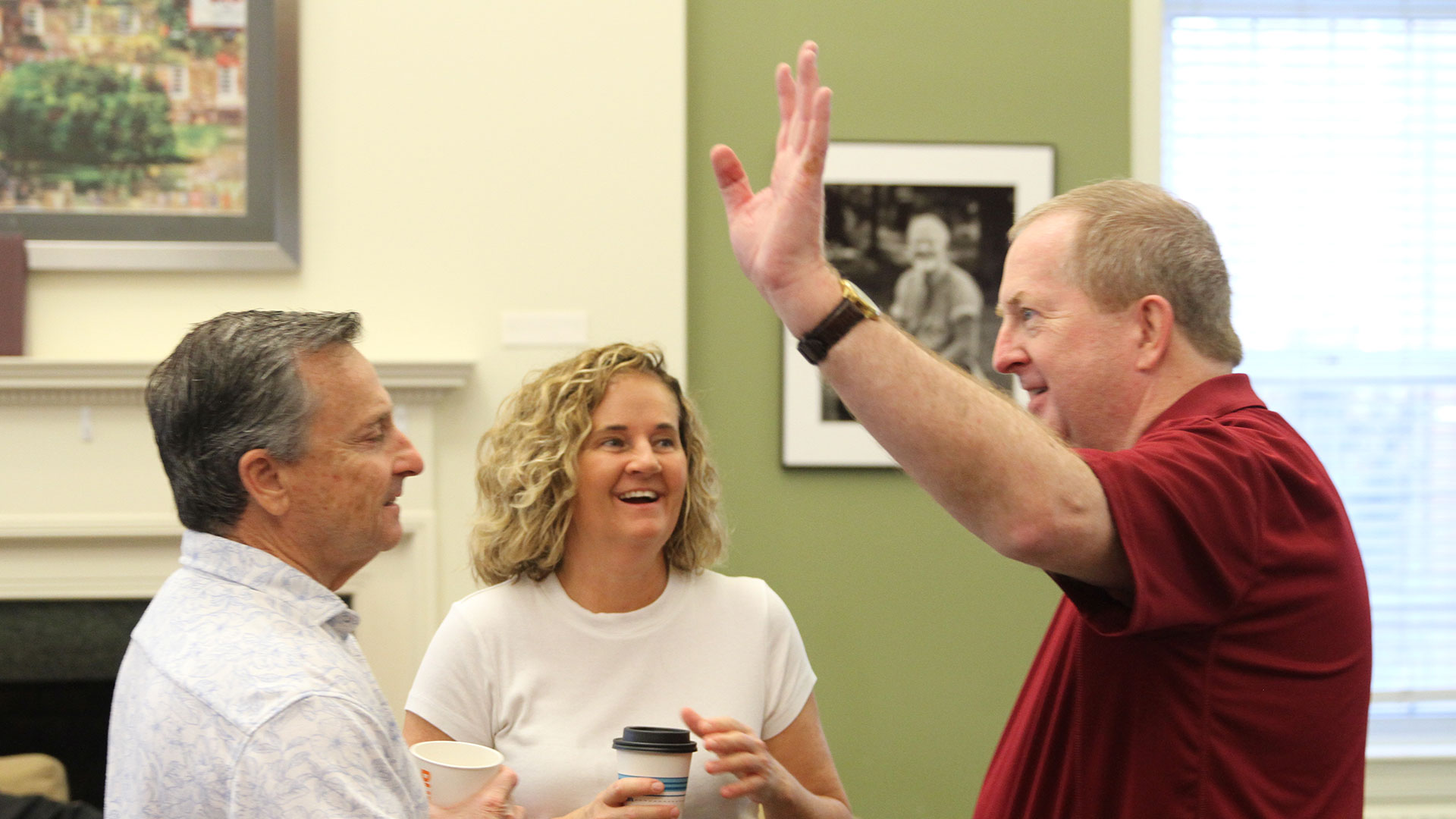 Guilford's Ty Buckner shares a story with first-year parents Laura and Wally White, whose son Keaton is a first year.