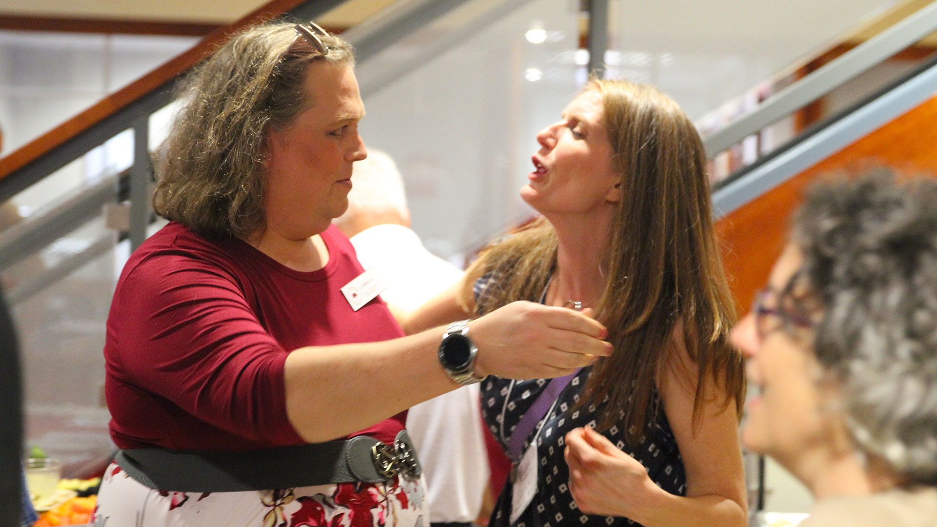 Classmates D Summers '00 and Sarah Bernhardt Petersen '00 meet at Friday's opening reception.