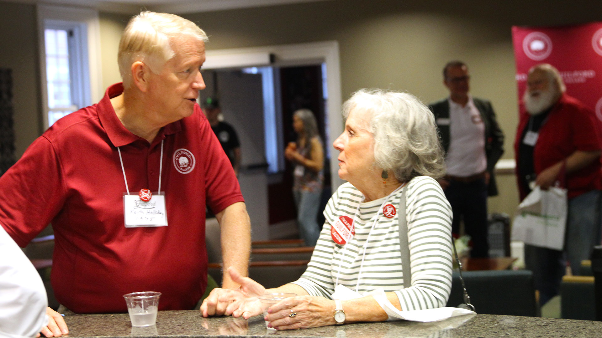 Keith Holiday '75 and ???? catch up at Friday's opening reception.