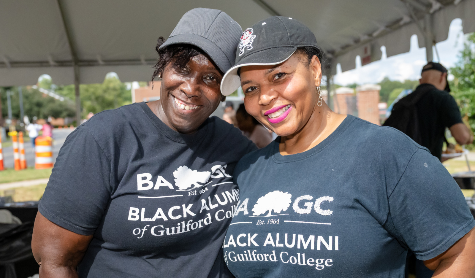 Ruby Phipps '01 and Toiya Hancock '93 take time our from the Black Alumni of Guilford College's homecoming fish fry.  