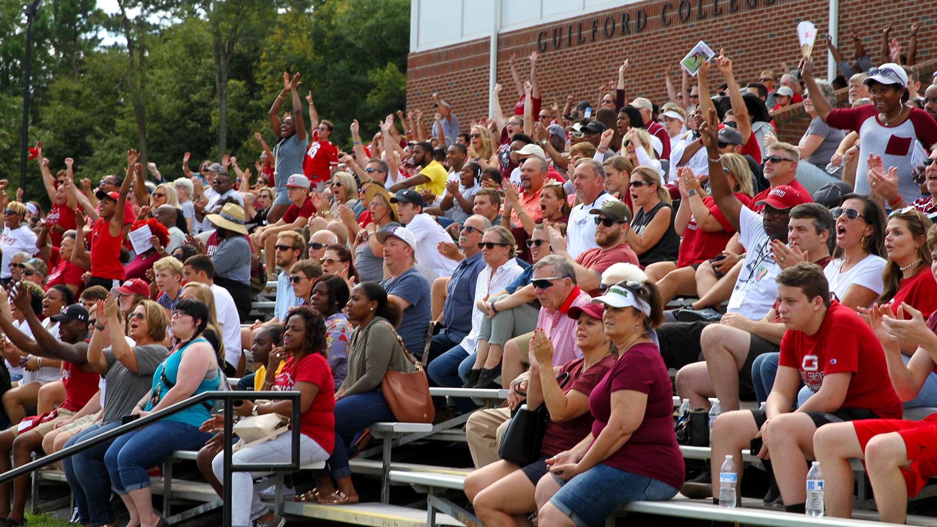 The stands fill up and fans cheer as Guilford takes on Bridgewater at the Homecoming football game.