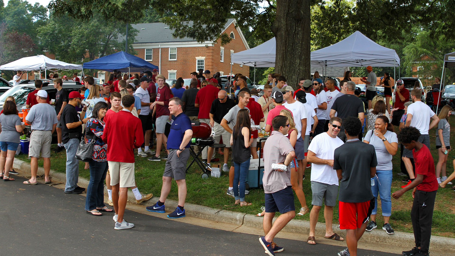 The lawn near the football stadium is packed with tailgaters at Homecoming.