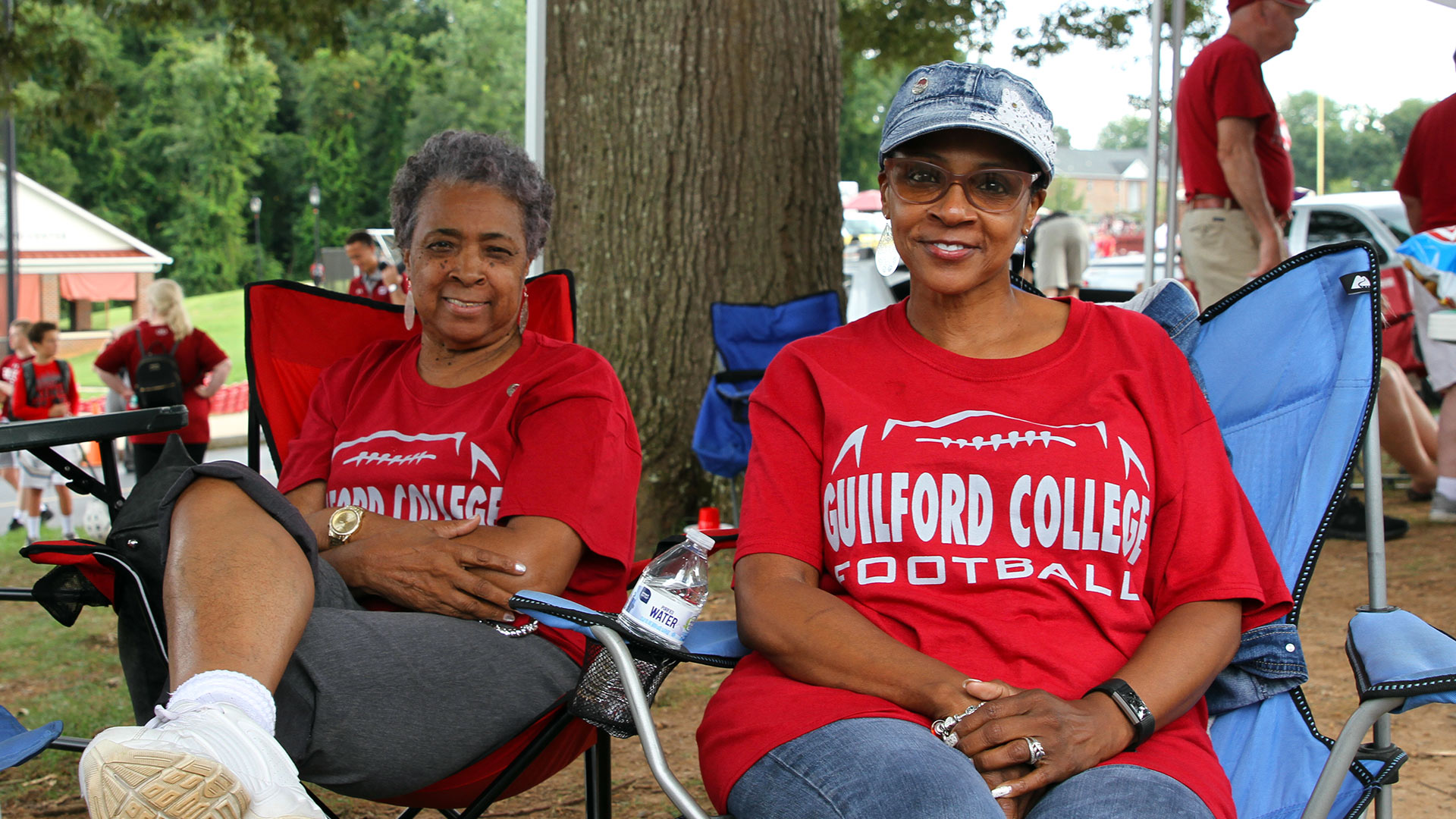 Guilfordians wearing red football shirts enjoy tailgating at Homecoming.