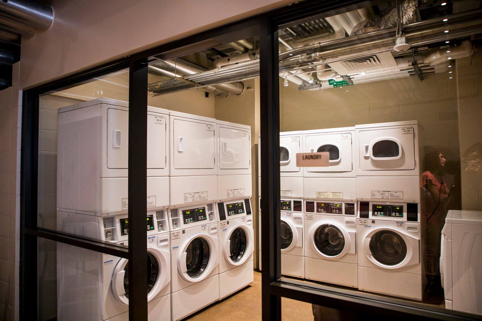 The laundry station is filled with brand new appliances ready for student use.