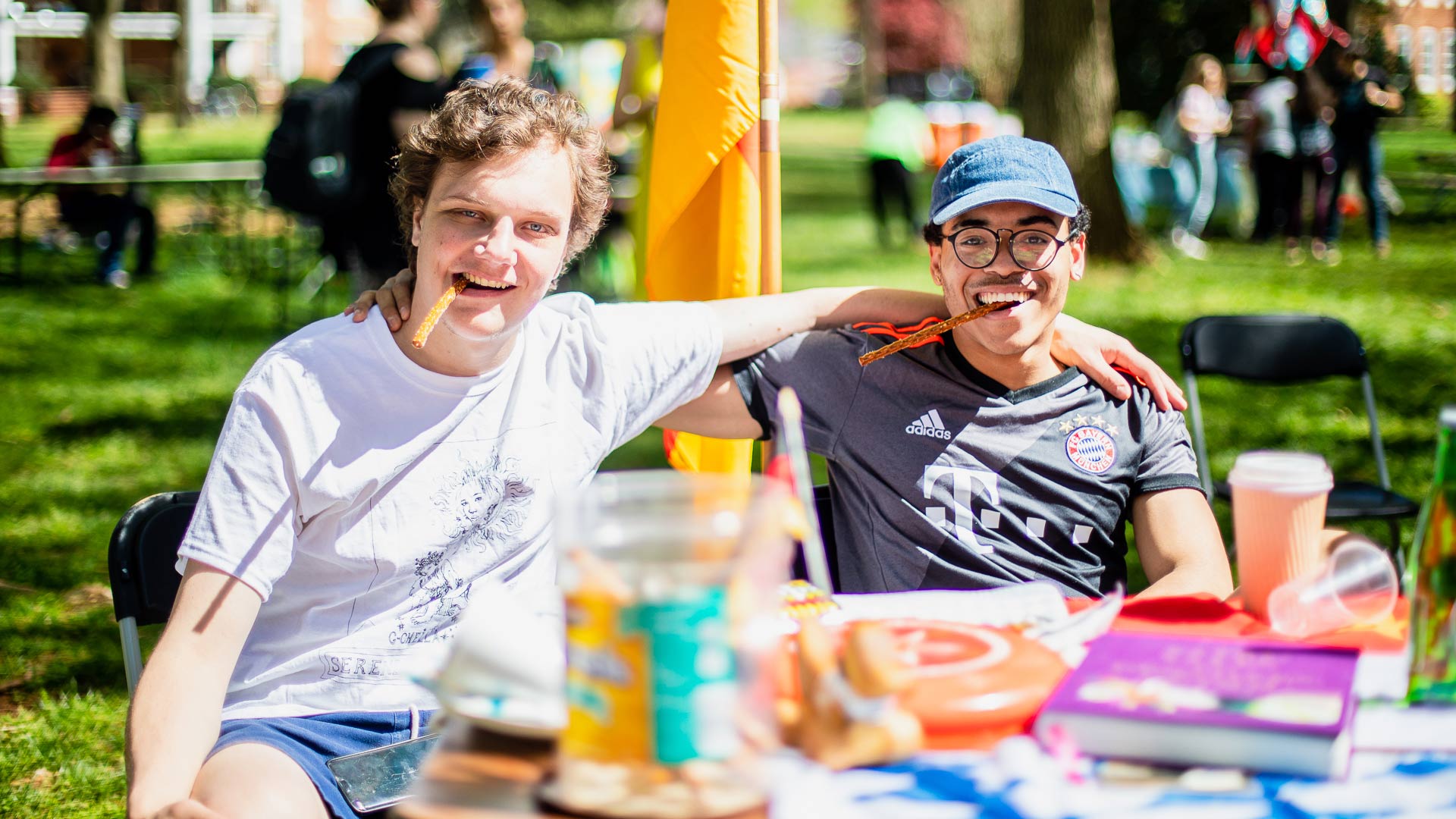 Two Guilford students sit at a table during the International Festival.