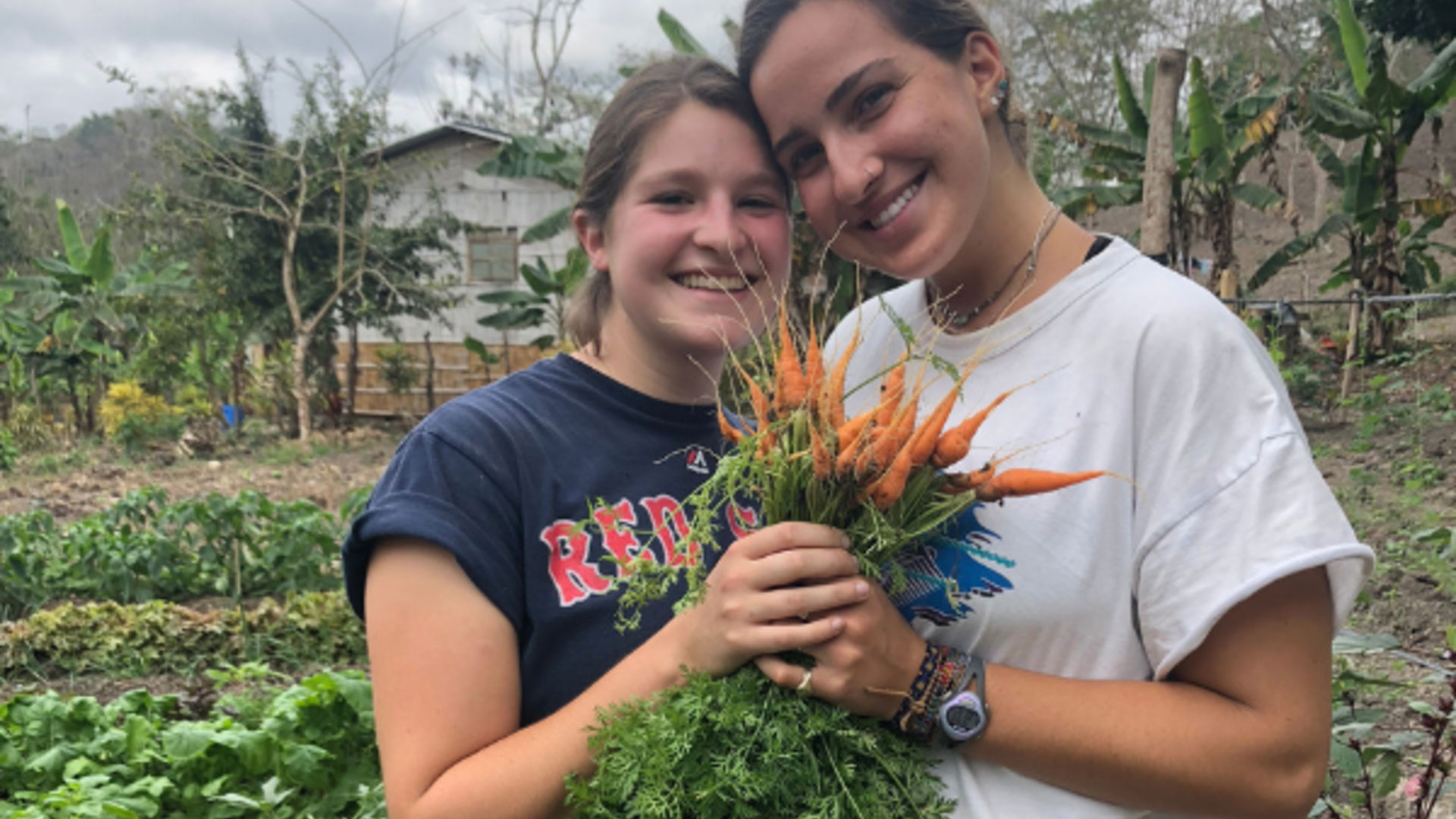 Student Mallory Cerkleski and a friend pick flowers and take a selfie.