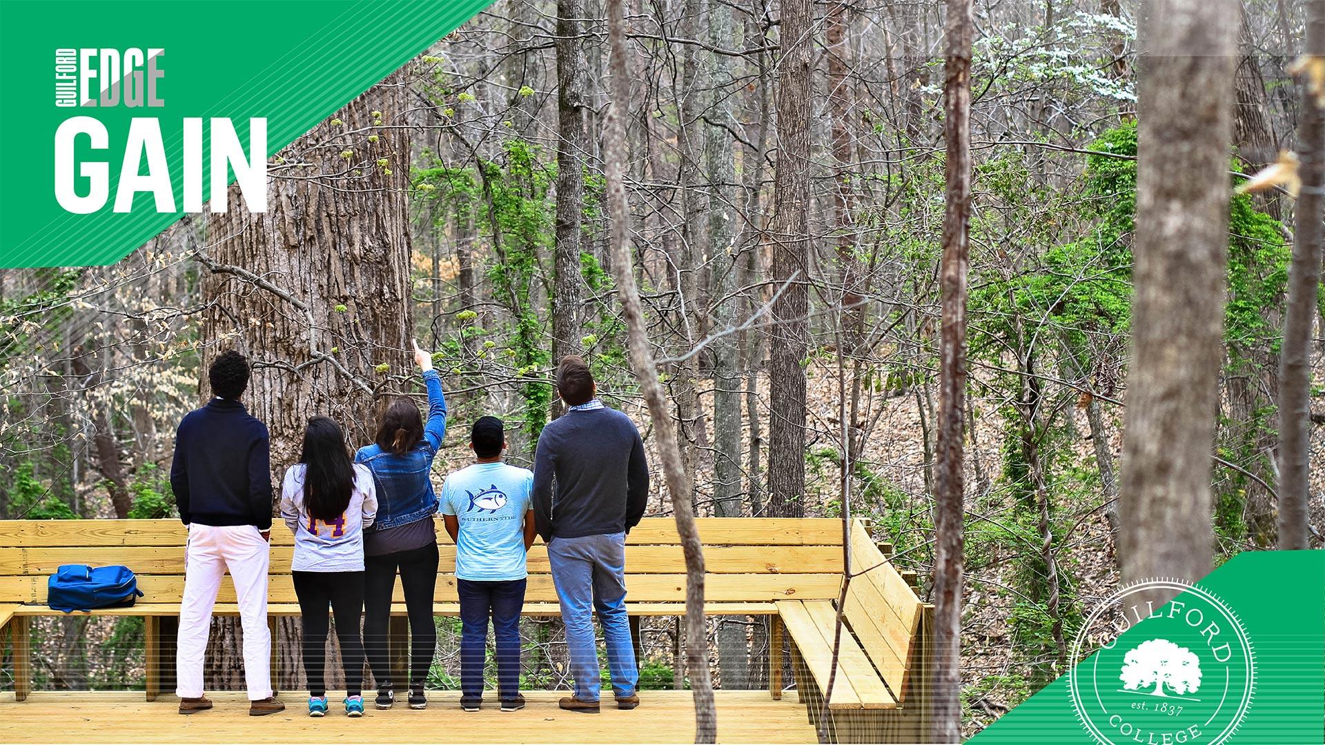 Students stand on the platform below the Underground Railroad Tree on Guilford campus, gaining a sense of ethical leadership as they discuss Guilford's values.