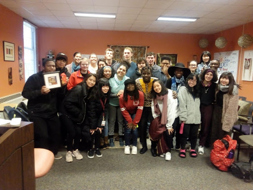 International student Samuel Odei poses for a group photo with his fellow Guilfordians.