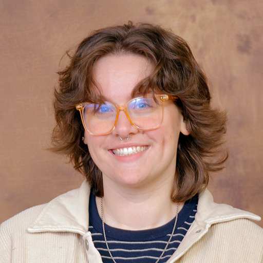 Liv Henderson wearing a blue shirt and tan jacket
