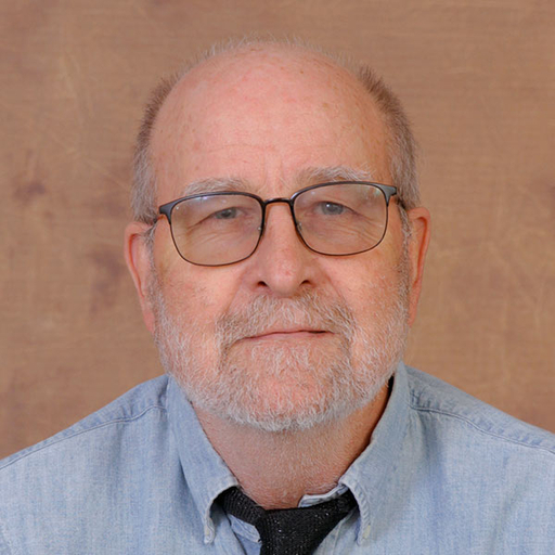 Bob Williams wearing a blue oxford shirt and dark tie