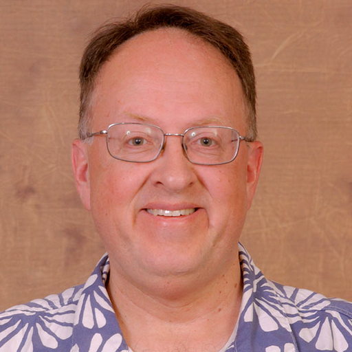 Don Smith in a blue shirt with a white flower print